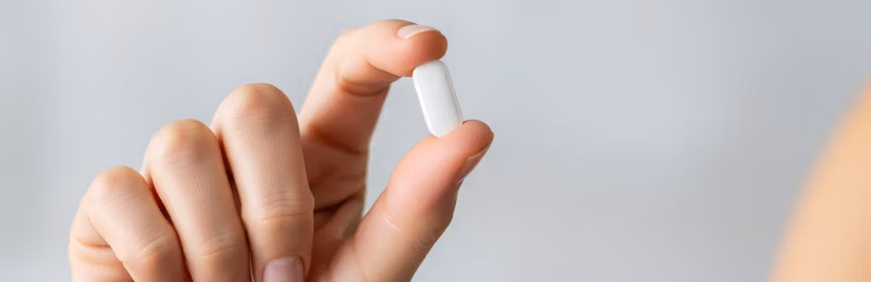 Hand holding multivitamin